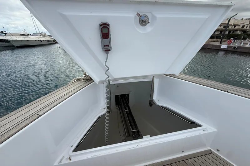 George Yacht Photos Pics Open hatch on 2024 Pardo Yachts 43, revealing storage compartment by the water.