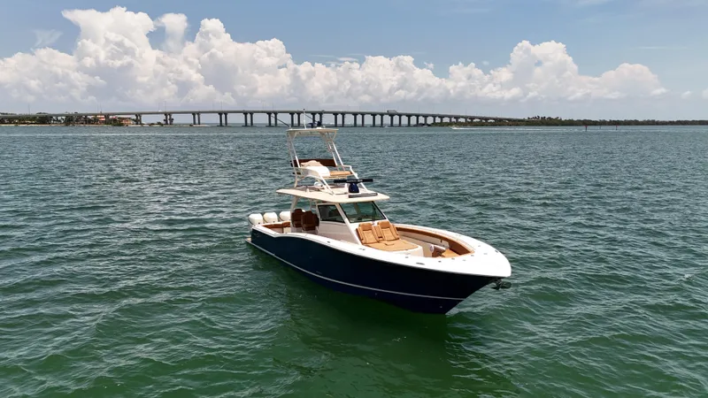  Yacht Photos Pics 2018 Scout 420 LXF boat on open water with bridge in background.