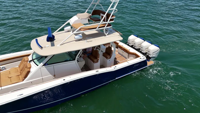  Yacht Photos Pics 2018 Scout 420 LXF boat with four engines cruising on open water.