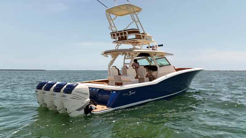  Yacht Photos Pics 2018 Scout 420 LXF boat with multiple engines on open water.