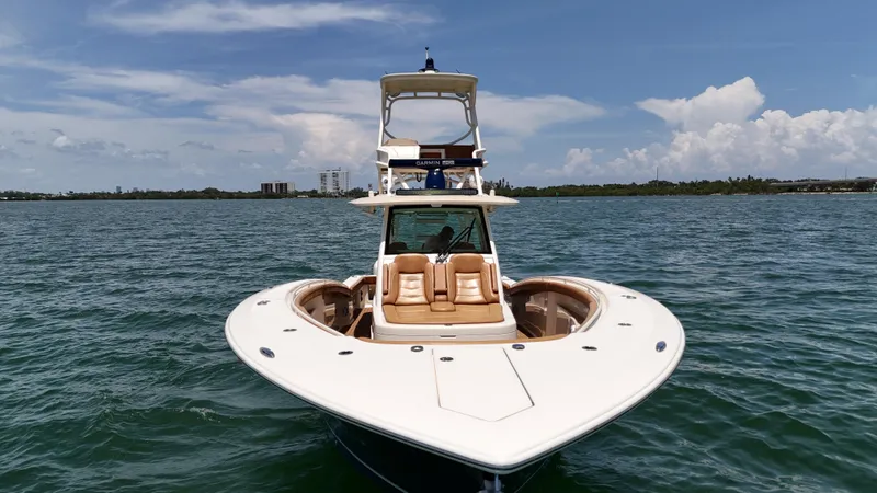  Yacht Photos Pics 2018 Scout 420 LXF boat on calm water under a clear sky.