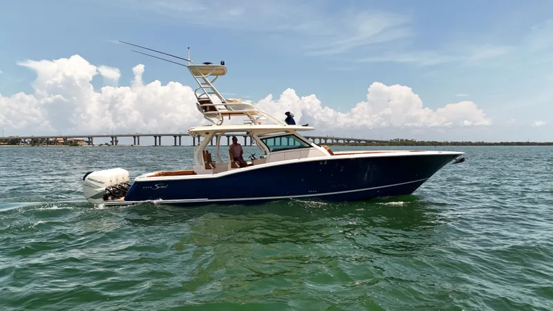  Yacht Photos Pics 2018 Scout 420 LXF boat cruising on open water under a clear sky.