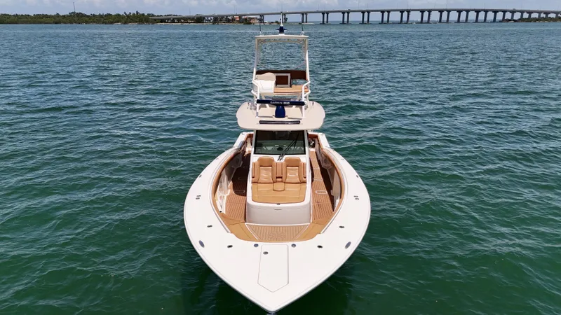  Yacht Photos Pics 2018 Scout 420 LXF boat on water with bridge in background.