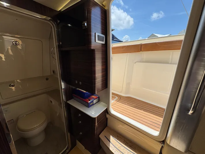  Yacht Photos Pics Interior of 2018 Scout 420 LXF boat showing bathroom and deck area.