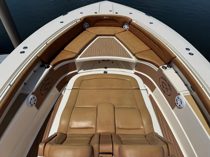  Yacht Photos Pics 2018 Scout 420 LXF boat interior with tan leather seating and wood accents.