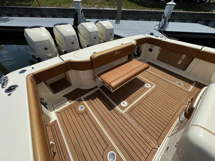  Yacht Photos Pics 2018 Scout 420 LXF boat with teak deck and quad outboard engines at dock.