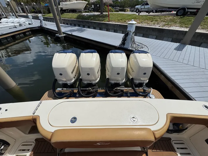  Yacht Photos Pics 2018 Scout 420 LXF boat with four powerful outboard engines at a marina dock.