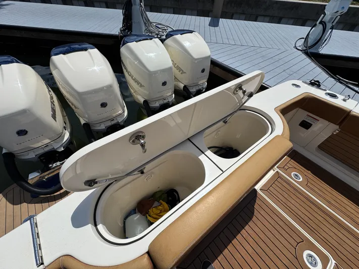  Yacht Photos Pics 2018 Scout 420 LXF boat with open storage compartments and four outboard engines.