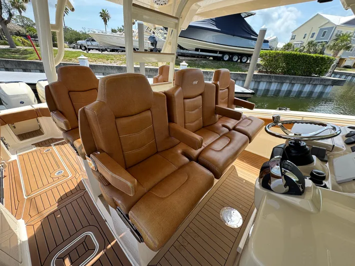  Yacht Photos Pics 2018 Scout 420 LXF boat with luxurious brown leather seating and sleek helm design.