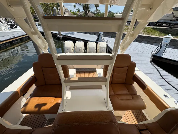  Yacht Photos Pics 2018 Scout 420 LXF boat interior with brown leather seating and multiple outboard engines.