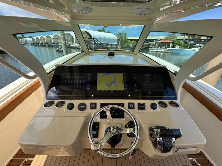  Yacht Photos Pics Helm of 2018 Scout 420 LXF boat with navigation display and controls.