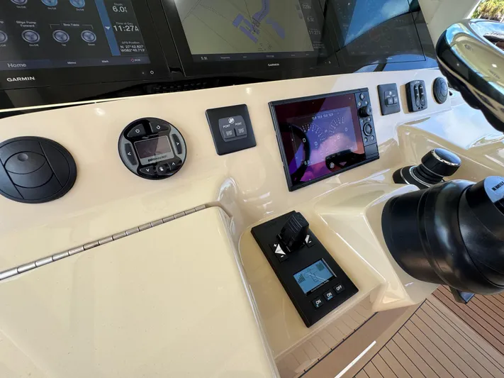 Yacht Photos Pics Control panel of a 2018 Scout 420 LXF boat with navigation screens and controls.