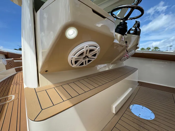  Yacht Photos Pics 2018 Scout 420 LXF boat interior with speaker and steering wheel.