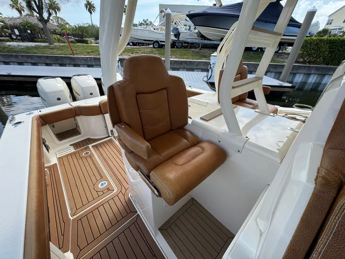  Yacht Photos Pics 2018 Scout 420 LXF boat interior with luxurious seating and teak flooring.