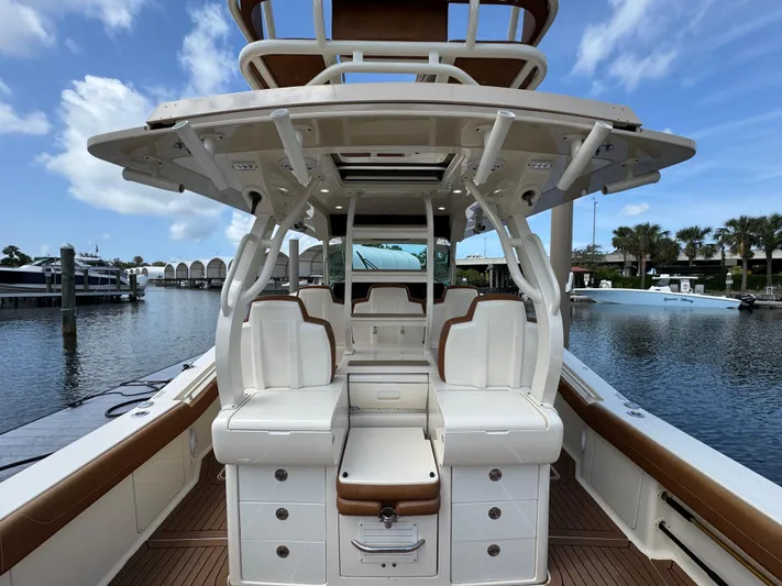  Yacht Photos Pics 2018 Scout 420 LXF boat interior with seating and storage, docked at marina.