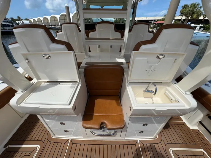  Yacht Photos Pics 2018 Scout 420 LXF boat interior with seating, storage, and sink on deck.