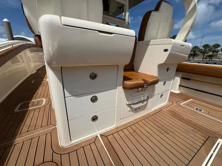  Yacht Photos Pics 2018 Scout 420 LXF boat interior with teak flooring and storage compartments.