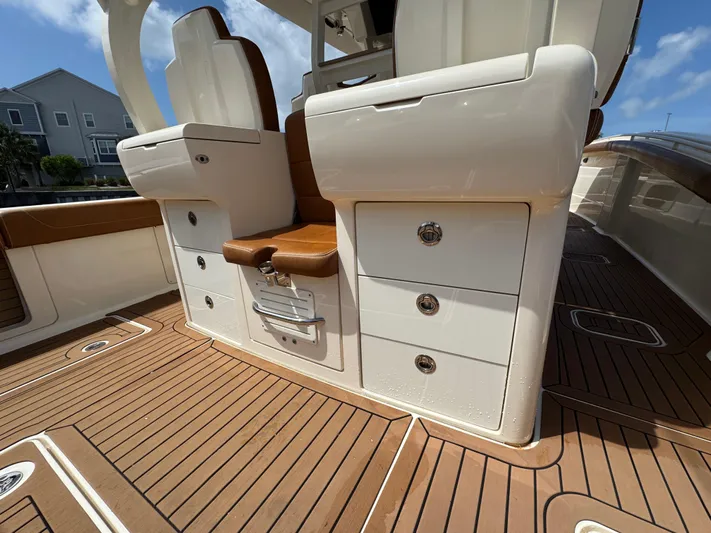  Yacht Photos Pics 2018 Scout 420 LXF boat interior with teak flooring and white seating.