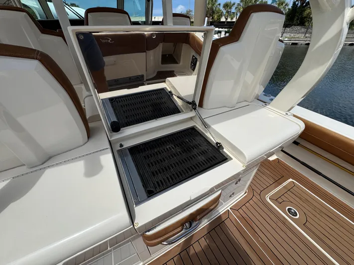  Yacht Photos Pics 2018 Scout 420 LXF boat interior with seating and storage compartments.