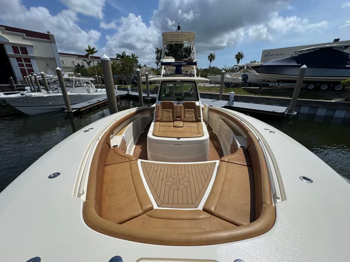  Yacht Photos Pics 2018 Scout 420 LXF boat with luxurious seating and sleek design at a marina.