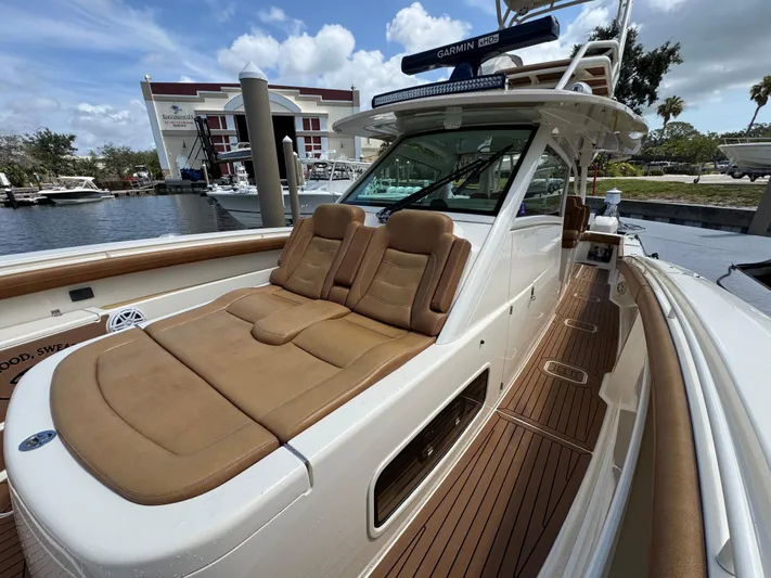  Yacht Photos Pics 2018 Scout 420 LXF boat with tan seating, docked at marina.