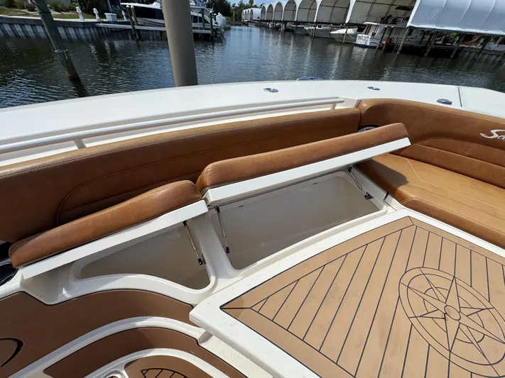  Yacht Photos Pics 2018 Scout 420 LXF boat interior with tan seating and storage compartments.