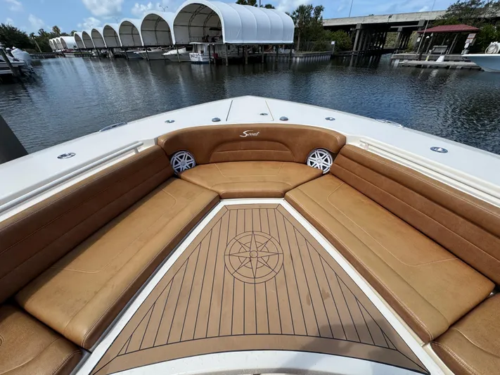  Yacht Photos Pics 2018 Scout 420 LXF boat with tan seating and wooden deck, docked at marina.