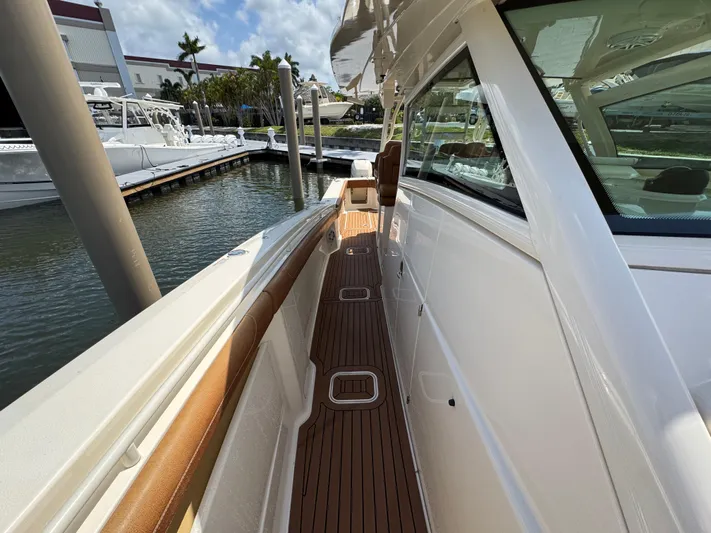  Yacht Photos Pics 2018 Scout 420 LXF yacht with sleek deck design docked at marina.