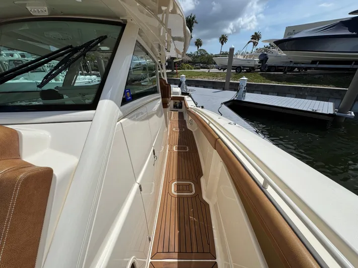  Yacht Photos Pics 2018 Scout 420 LXF boat deck with teak flooring and luxurious seating.