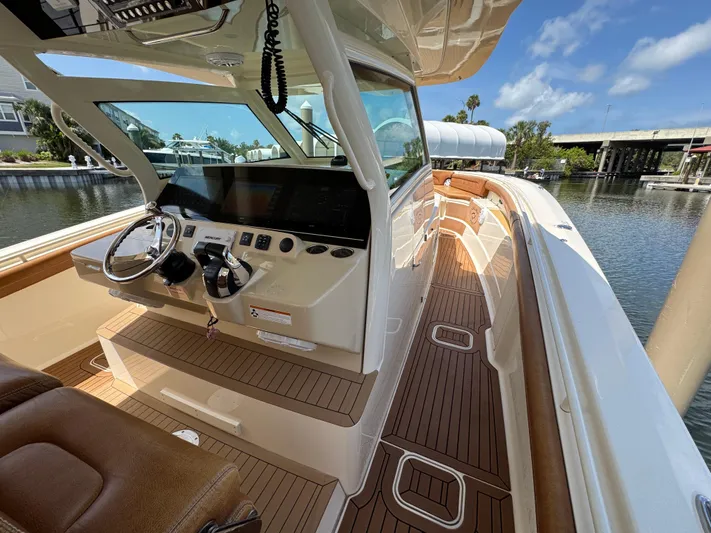  Yacht Photos Pics 2018 Scout 420 LXF boat interior with sleek helm and wooden deck.
