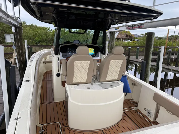  Yacht Photos Pics 2024 Chris-Craft Catalina 30 boat interior with dual seats and wood flooring.