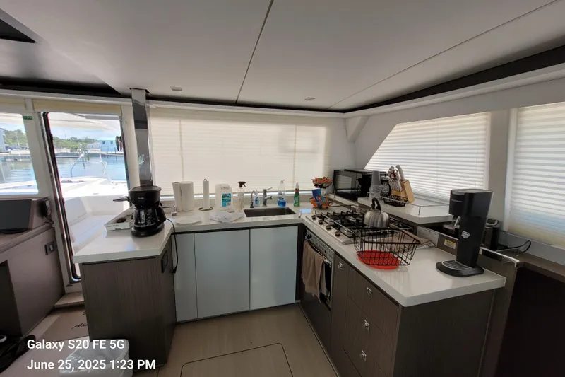 Making Connections II Yacht Photos Pics Modern kitchen interior on a 2022 Leopard 45 yacht, featuring appliances and ample counter space.