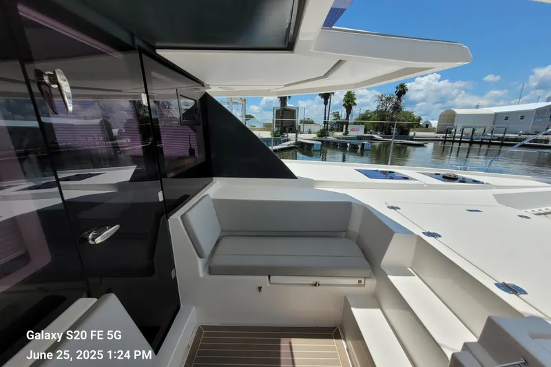 Making Connections II Yacht Photos Pics Leopard 45 yacht interior, 2022 model, featuring sleek seating and modern design at a marina.