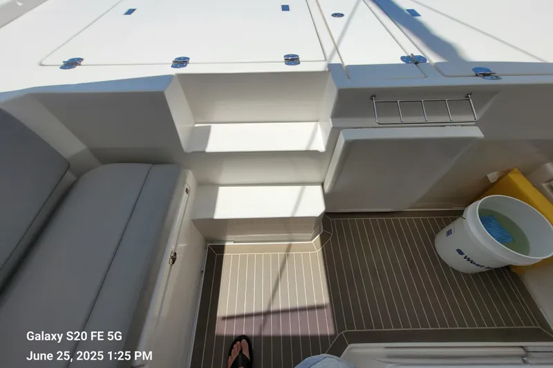 Making Connections II Yacht Photos Pics Interior of a 2022 Leopard 45 yacht, featuring seating and a bucket on the deck.