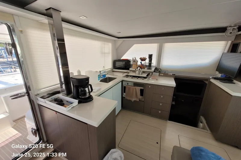 Making Connections II Yacht Photos Pics Modern kitchen interior on a 2022 Leopard 45 yacht, featuring sleek countertops and appliances.
