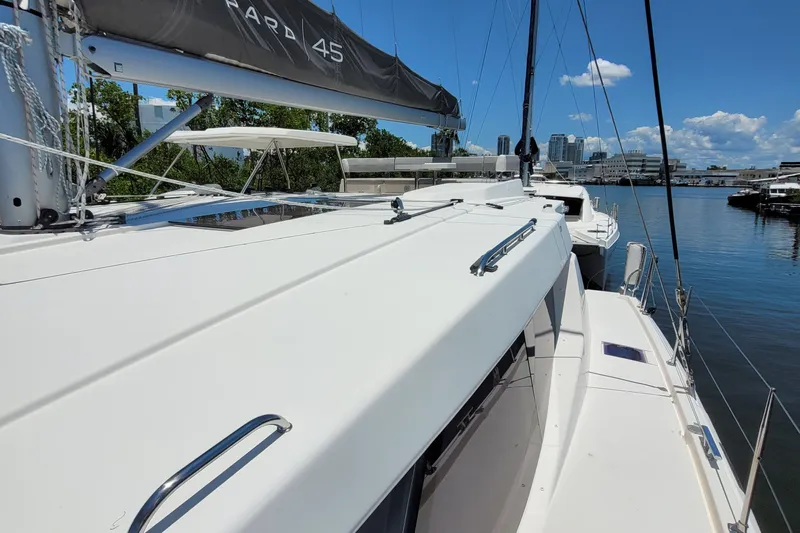 Making Connections II Yacht Photos Pics 2022 Leopard 45 catamaran docked, showcasing sleek design and spacious deck.