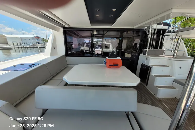 Making Connections II Yacht Photos Pics Interior of 2022 Leopard 45 yacht with seating and table, dockside view.