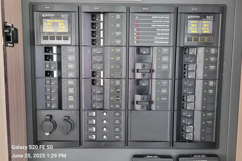 Making Connections II Yacht Photos Pics Electrical control panel on a 2022 Leopard 45 yacht, featuring various switches and displays.