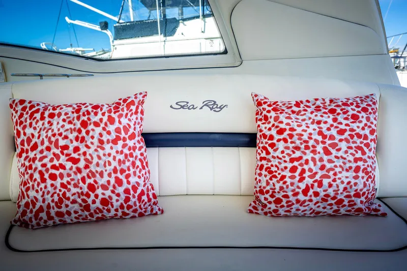 Nauti Lis Yacht Photos Pics Interior of 2005 Sea Ray 500 Sundancer with red-patterned cushions on white seating.