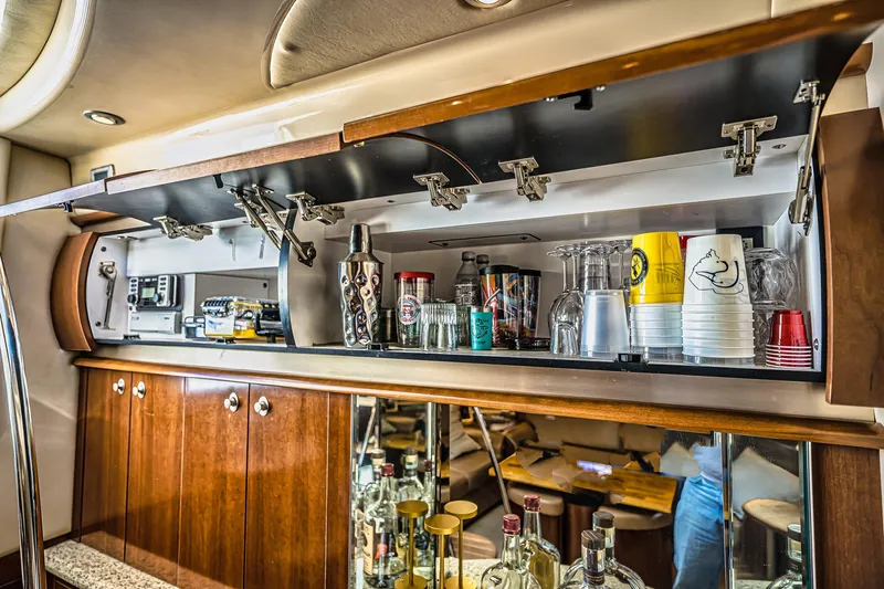 Nauti Lis Yacht Photos Pics Luxurious bar area inside a 2005 Sea Ray 500 Sundancer yacht, featuring glassware and beverages.