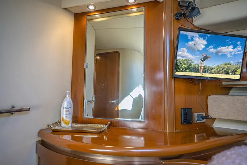 Nauti Lis Yacht Photos Pics Luxurious 2005 Sea Ray 500 Sundancer interior with mirror, TV, and wooden cabinetry.