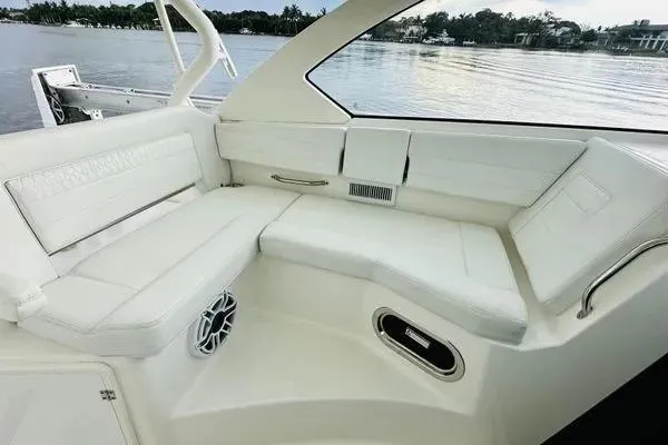  Yacht Photos Pics 2023 Pursuit OS 355 Offshore boat interior with white seating and scenic water view.