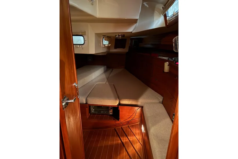 Gate Of Horn Yacht Photos Pics Interior cabin of 1988 Sabre 42 sailboat with wooden finish and cushioned seating.