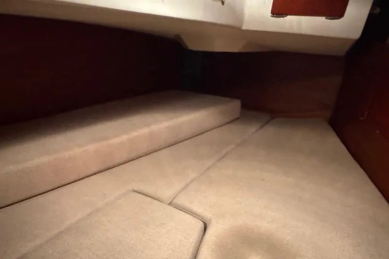 Gate Of Horn Yacht Photos Pics Interior cabin of 1988 Sabre 42 sailboat with beige cushions and wooden accents.