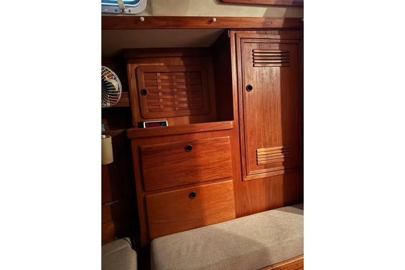 Gate Of Horn Yacht Photos Pics Wooden interior of 1988 Sabre 42 yacht, featuring cabinets and drawers.