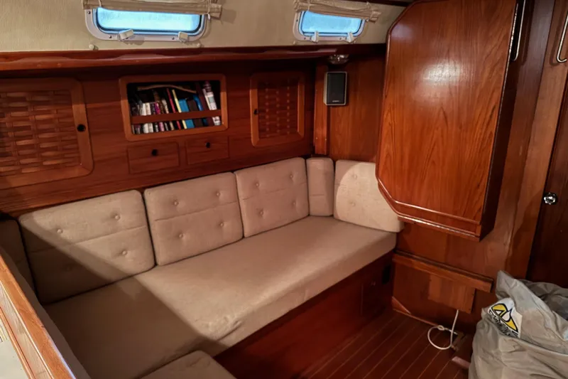 Gate Of Horn Yacht Photos Pics Cozy interior of 1988 Sabre 42 sailboat with wooden cabinetry and cushioned seating.