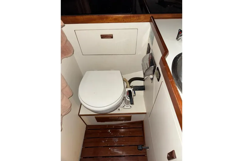 Gate Of Horn Yacht Photos Pics 1988 Sabre 42 yacht bathroom with wooden accents and compact toilet.