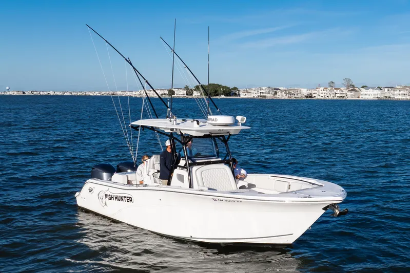 Fish Hunter Yacht Photos Pics 2021 Sea Fox 288 Commander boat on water, equipped for fishing, with coastal background.