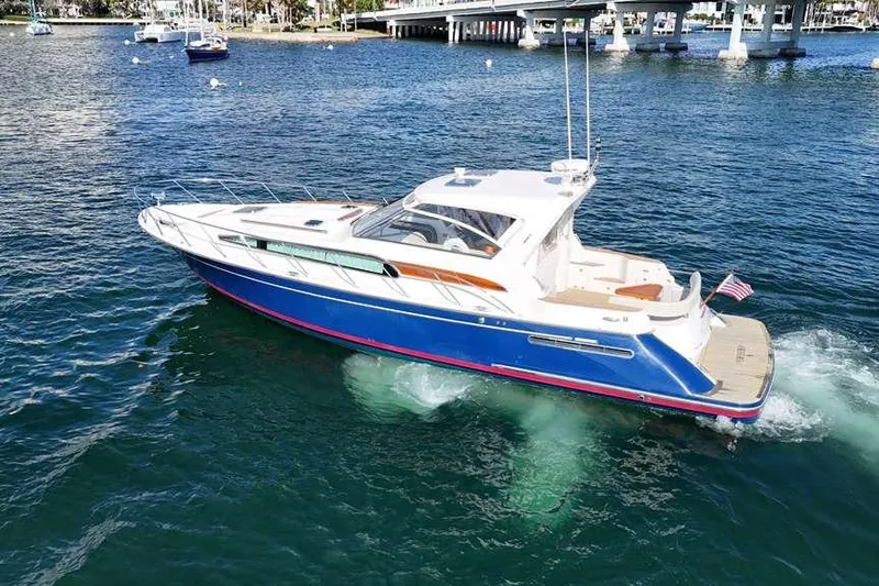 Split Decision Yacht Photos Pics 2007 Chris-Craft Roamer 40 yacht cruising on blue water near a bridge.