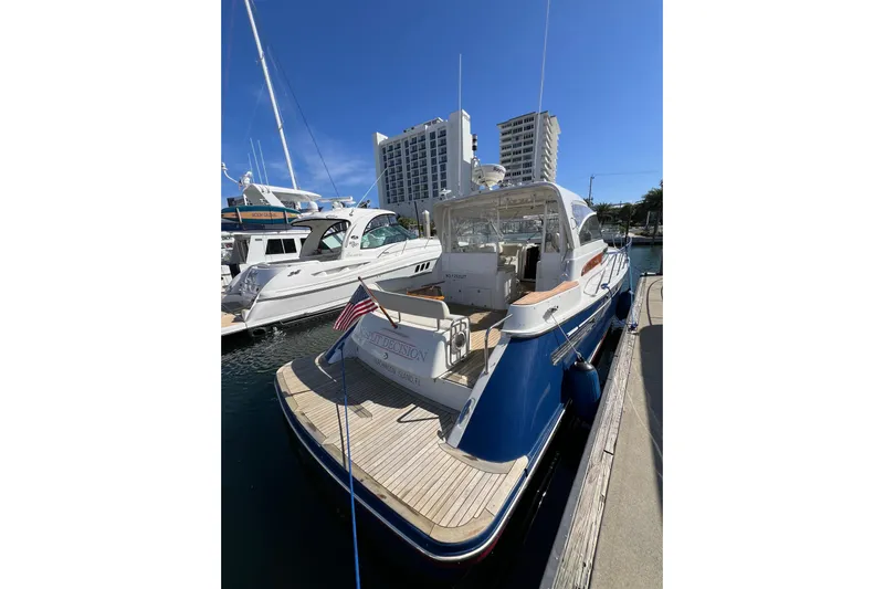 Split Decision Yacht Photos Pics 2007 Chris-Craft Roamer 40 yacht docked at marina with cityscape background.